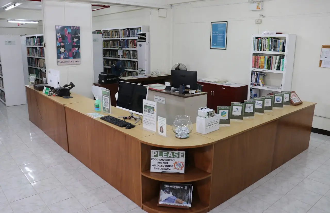Circulation desk with library staff assisting students